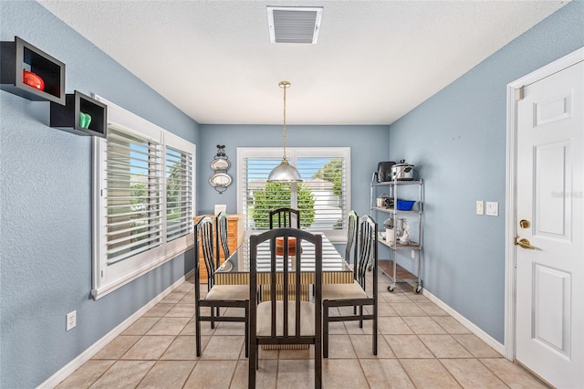 13643 SE 89th Ct, Summerfield, FL 34491 - dining space featuring light tile patterned flooring, baseboards, and a textured wall