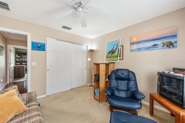 13643 SE 89th Ct, Summerfield, FL 34491 - living area with carpet, a ceiling fan, and baseboards