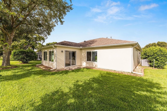 13643 SE 89th Ct, Summerfield, FL 34491 - rear view of property featuring a yard and stucco siding