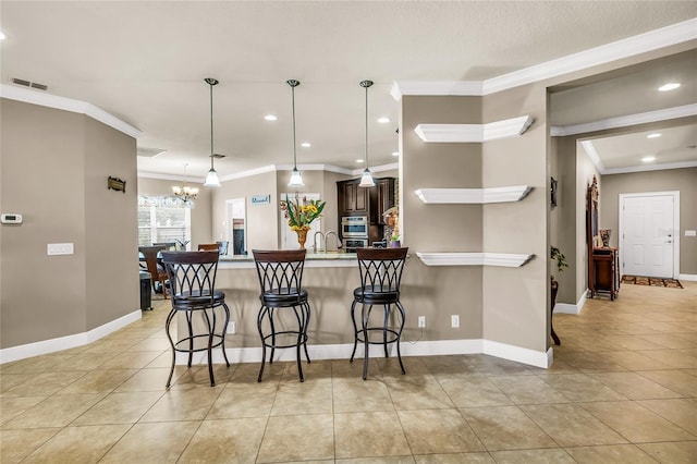 3222 San Leo Dr, Orlando, FL 32820 - kitchen with a kitchen breakfast bar, a peninsula, light tile patterned flooring, a chandelier, and crown molding
