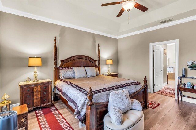 3222 San Leo Dr, Orlando, FL 32820 - bedroom with light wood-style flooring, a raised ceiling, crown molding, and ensuite bathroom