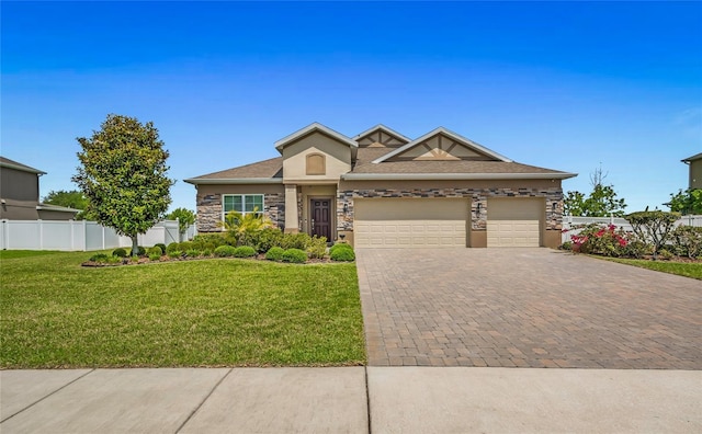 3222 San Leo Dr, Orlando, FL 32820 - view of front of house featuring decorative driveway, a garage, stone siding, and stucco siding