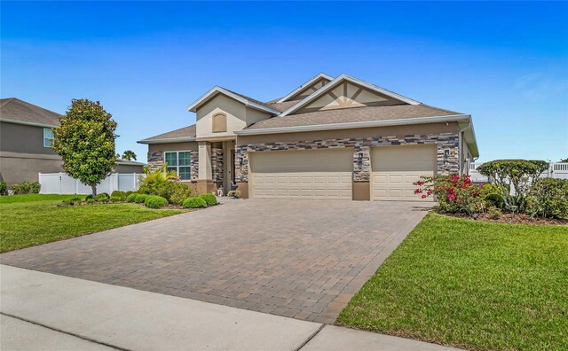 3222 San Leo Dr, Orlando, FL 32820 - ranch-style house featuring a garage, decorative driveway, stucco siding, and stone siding