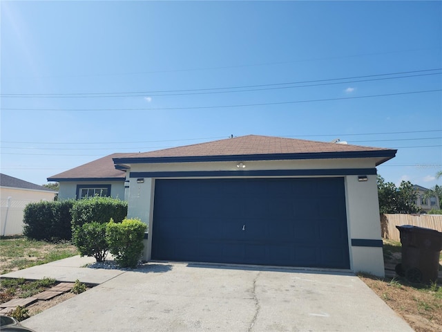 112 Arlington Ct, Haines City, FL 33844 - ranch-style house with stucco siding, concrete driveway, and a garage