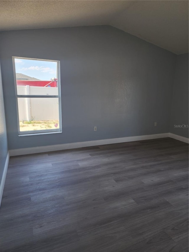 112 Arlington Ct, Haines City, FL 33844 - bonus room with lofted ceiling, baseboards, and dark wood-style flooring