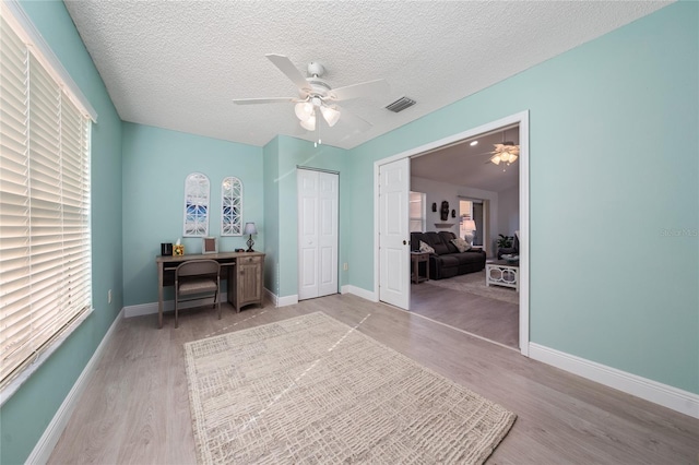 9430 SE 176th Saffold St, The Villages, FL 32162 - office space with light wood-style floors, a ceiling fan, a textured ceiling, and baseboards