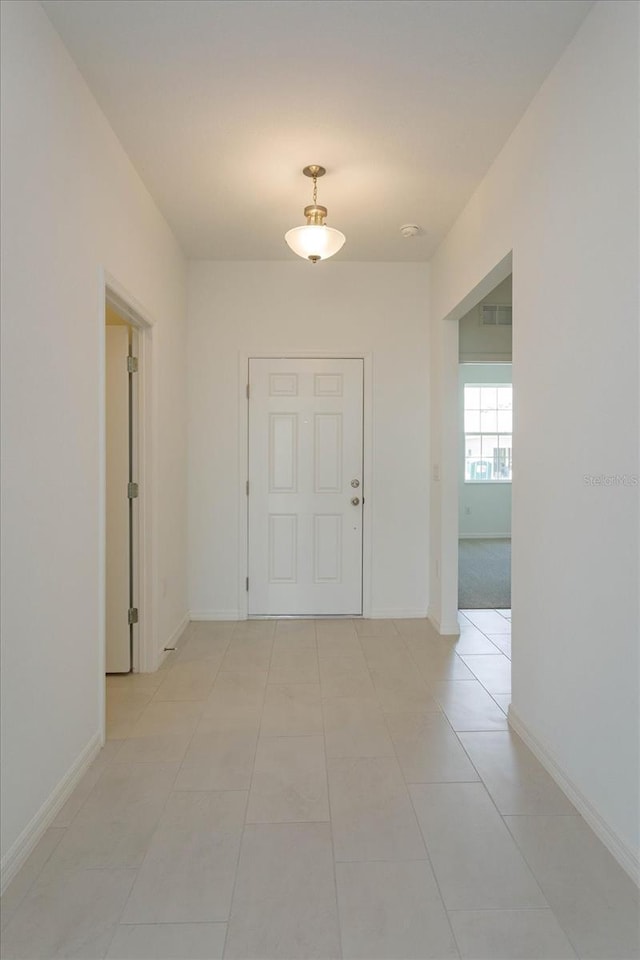 520 Silver Palm Dr, Haines City, FL 33844 - corridor featuring baseboards and light tile patterned floors