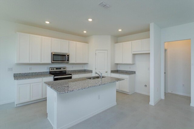 520 Silver Palm Dr, Haines City, FL 33844 - kitchen with appliances with stainless steel finishes, a sink, white cabinets, recessed lighting, and light stone countertops