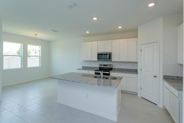 520 Silver Palm Dr, Haines City, FL 33844 - kitchen featuring stainless steel appliances, a chandelier, white cabinets, recessed lighting, and light stone countertops