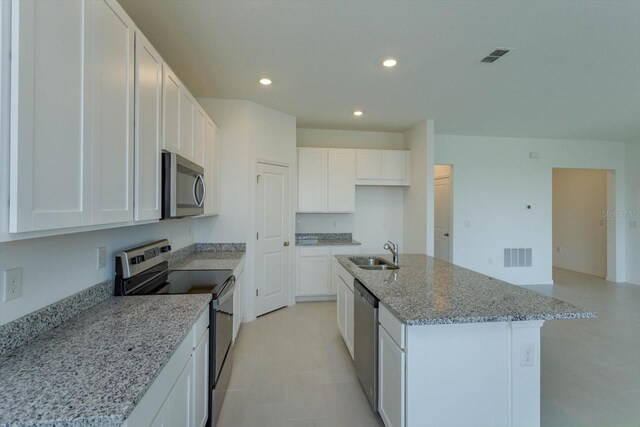520 Silver Palm Dr, Haines City, FL 33844 - kitchen featuring stainless steel appliances, a sink, a center island with sink, recessed lighting, and light stone countertops