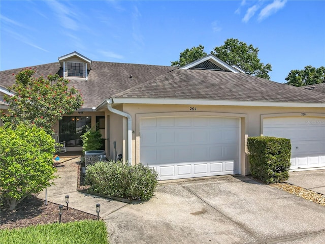 264 Juniper Way, Tavares, FL 32778 - view of front of property featuring roof with shingles, driveway, stucco siding, and central AC unit