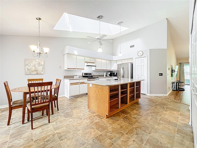 264 Juniper Way, Tavares, FL 32778 - kitchen with appliances with stainless steel finishes, baseboards, under cabinet range hood, a skylight, and high vaulted ceiling