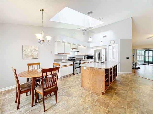 264 Juniper Way, Tavares, FL 32778 - kitchen featuring stainless steel appliances, under cabinet range hood, baseboards, high vaulted ceiling, and white cabinets