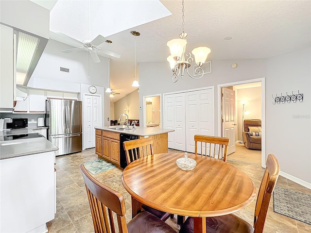 264 Juniper Way, Tavares, FL 32778 - dining space featuring vaulted ceiling, a ceiling fan, a chandelier, light stone finish flooring, and a textured ceiling