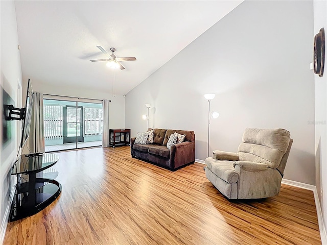 264 Juniper Way, Tavares, FL 32778 - living area featuring light wood finished floors, a ceiling fan, baseboards, and high vaulted ceiling
