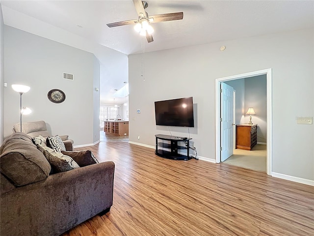 264 Juniper Way, Tavares, FL 32778 - living area with light wood finished floors, a ceiling fan, baseboards, and vaulted ceiling