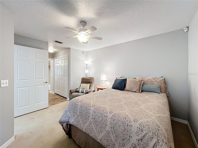 264 Juniper Way, Tavares, FL 32778 - bedroom with light carpet, baseboards, a closet, a ceiling fan, and a textured ceiling