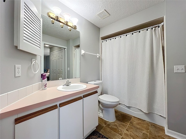 264 Juniper Way, Tavares, FL 32778 - full bath with vanity, toilet, a textured ceiling, shower / tub combo with curtain, and stone finish flooring