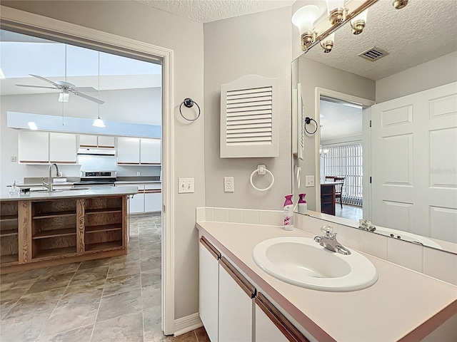 264 Juniper Way, Tavares, FL 32778 - bathroom featuring a textured ceiling, vanity, baseboards, ceiling fan, and stone finish flooring