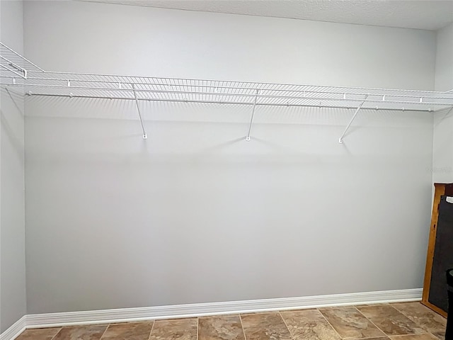 264 Juniper Way, Tavares, FL 32778 - walk in closet with stone finish flooring