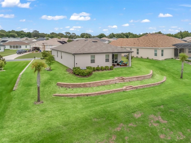 17108 SE 111th Terrace Rd, Summerfield, FL 34491 - rear view of property with a lawn, a residential view, and stucco siding