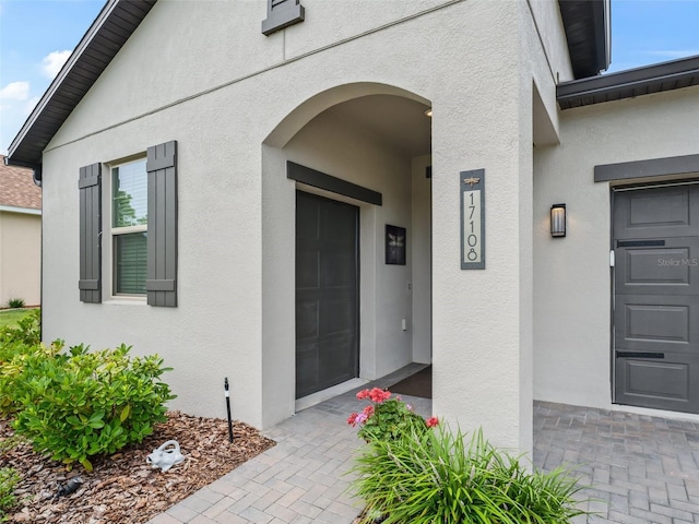 17108 SE 111th Terrace Rd, Summerfield, FL 34491 - doorway to property featuring stucco siding