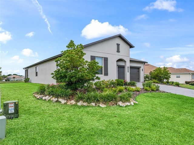 17108 SE 111th Terrace Rd, Summerfield, FL 34491 - view of front facade featuring driveway, an attached garage, stucco siding, and a front lawn