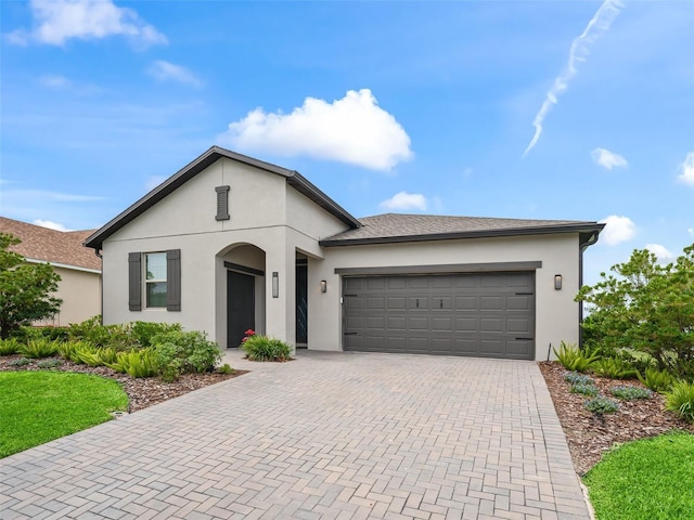 17108 SE 111th Terrace Rd, Summerfield, FL 34491 - view of front of property with decorative driveway, a garage, and stucco siding