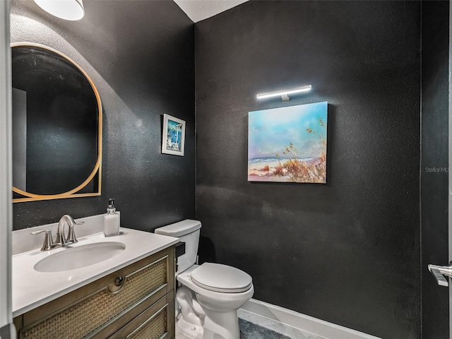 17108 SE 111th Terrace Rd, Summerfield, FL 34491 - half bathroom featuring toilet, vanity, tile patterned flooring, and baseboards