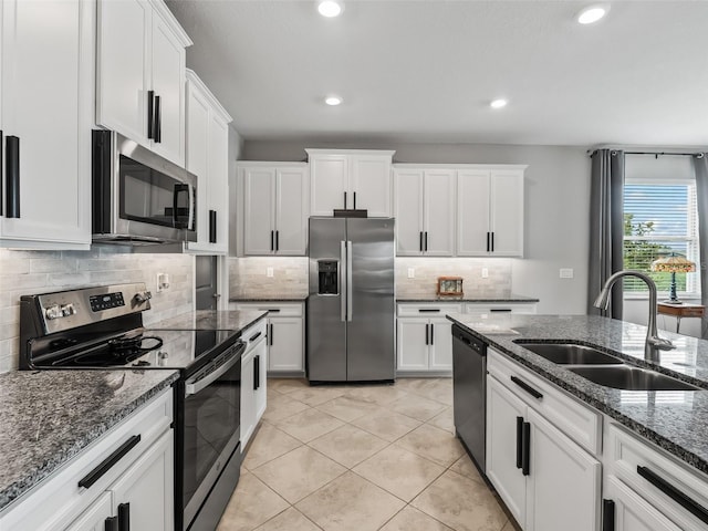 17108 SE 111th Terrace Rd, Summerfield, FL 34491 - kitchen featuring appliances with stainless steel finishes, a sink, white cabinetry, decorative backsplash, and recessed lighting