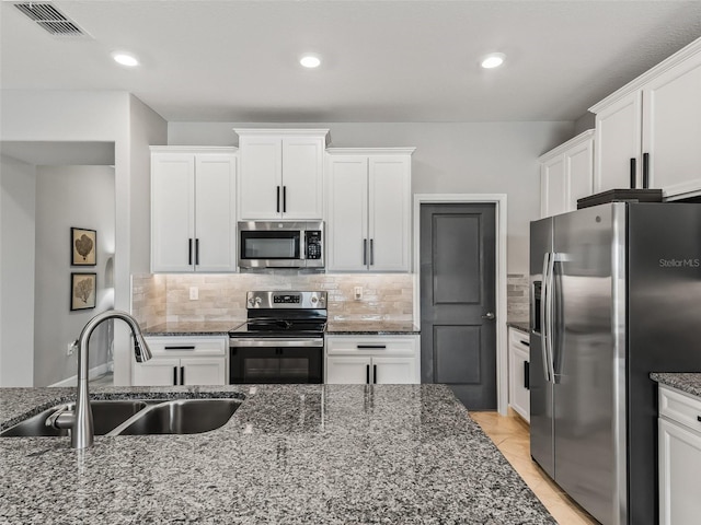 17108 SE 111th Terrace Rd, Summerfield, FL 34491 - kitchen with appliances with stainless steel finishes, a sink, white cabinets, and recessed lighting