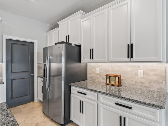 17108 SE 111th Terrace Rd, Summerfield, FL 34491 - kitchen featuring stainless steel fridge, white cabinetry, tasteful backsplash, and light stone countertops