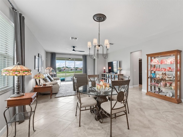 17108 SE 111th Terrace Rd, Summerfield, FL 34491 - dining area featuring a chandelier, ceiling fan, light tile patterned floors, and baseboards