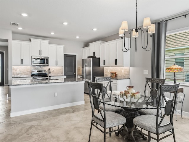 17108 SE 111th Terrace Rd, Summerfield, FL 34491 - dining area featuring a chandelier, recessed lighting, light tile patterned floors, and baseboards