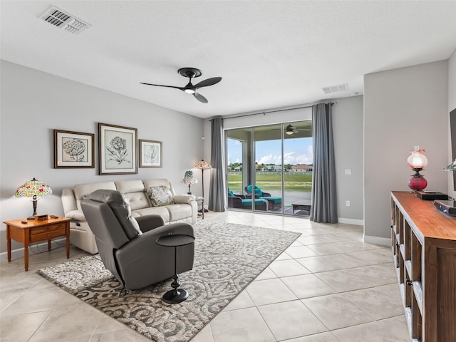 17108 SE 111th Terrace Rd, Summerfield, FL 34491 - living area with light tile patterned flooring, a ceiling fan, and baseboards