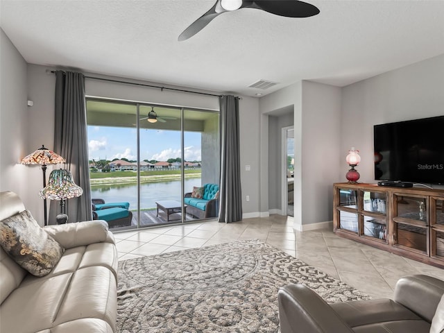 17108 SE 111th Terrace Rd, Summerfield, FL 34491 - tiled living room featuring a ceiling fan, healthy amount of natural light, and a textured ceiling