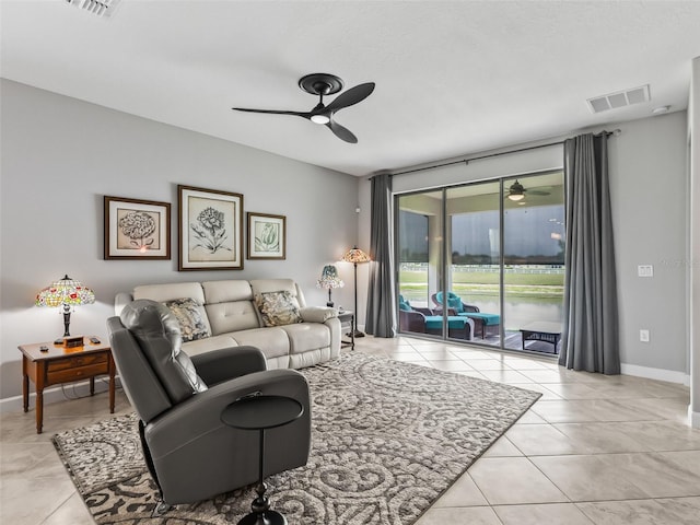 17108 SE 111th Terrace Rd, Summerfield, FL 34491 - living room with a ceiling fan, light tile patterned floors, and baseboards