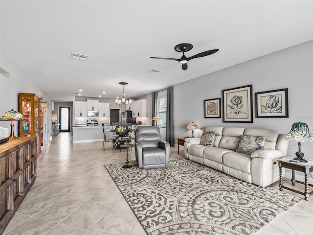 17108 SE 111th Terrace Rd, Summerfield, FL 34491 - living room with a ceiling fan, light tile patterned floors, a chandelier, and recessed lighting