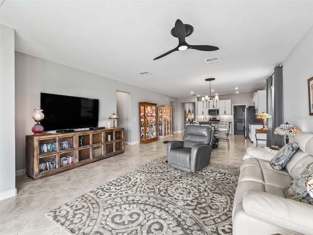 17108 SE 111th Terrace Rd, Summerfield, FL 34491 - living room featuring baseboards, a ceiling fan, and a chandelier