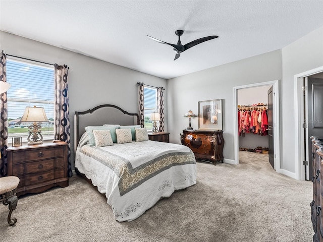 17108 SE 111th Terrace Rd, Summerfield, FL 34491 - bedroom with a spacious closet, carpet, a closet, a ceiling fan, and baseboards