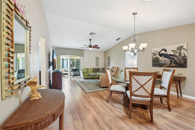 8039 SE 174th Belhaven Loop, The Villages, FL 32162 - dining area featuring vaulted ceiling, light wood finished floors, a ceiling fan, and a chandelier