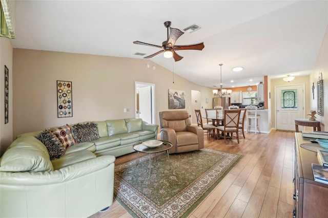 8039 SE 174th Belhaven Loop, The Villages, FL 32162 - living area with a ceiling fan, a chandelier, light wood-style flooring, and vaulted ceiling