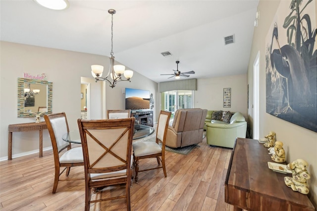 8039 SE 174th Belhaven Loop, The Villages, FL 32162 - dining room featuring light wood-style floors, a chandelier, vaulted ceiling, a ceiling fan, and baseboards