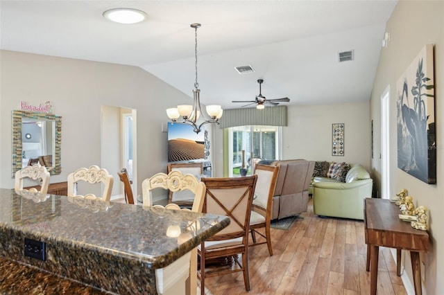8039 SE 174th Belhaven Loop, The Villages, FL 32162 - kitchen featuring lofted ceiling, a ceiling fan, light wood-style floors, a chandelier, and pendant lighting