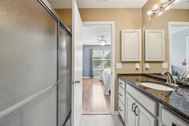 8039 SE 174th Belhaven Loop, The Villages, FL 32162 - full bath with a textured ceiling, vanity, baseboards, connected bathroom, and ceiling fan