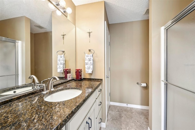 8039 SE 174th Belhaven Loop, The Villages, FL 32162 - bathroom featuring a textured ceiling, vanity, a shower with door, and baseboards