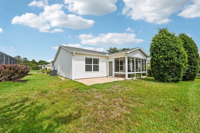 8039 SE 174th Belhaven Loop, The Villages, FL 32162 - rear view of house with central air condition unit, a patio, a sunroom, and a lawn