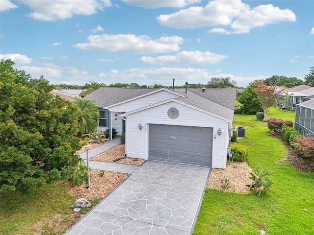 8039 SE 174th Belhaven Loop, The Villages, FL 32162 - ranch-style home with concrete driveway, a front lawn, an attached garage, roof with shingles, and central AC