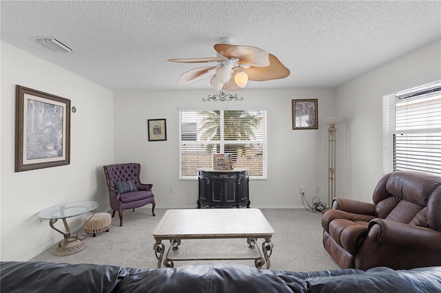 9321 SE 172nd Augusta Ln, The Villages, FL 32162 - living room featuring carpet floors, healthy amount of natural light, a textured ceiling, a ceiling fan, and baseboards
