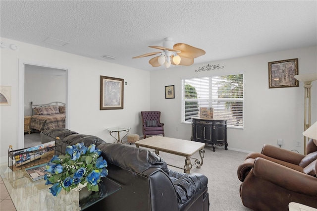 9321 SE 172nd Augusta Ln, The Villages, FL 32162 - carpeted living area featuring a textured ceiling, ceiling fan, and baseboards